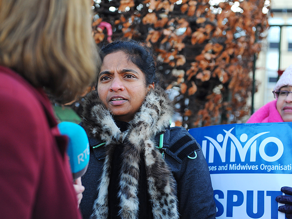 nurse doing media outdoors at a protest